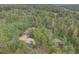 Scenic aerial view of a home with a detached garage, nestled among lush trees at 28858 Richmond Hill Rd, Conifer, CO 80433