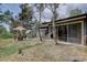 Home's outdoor space features a greenhouse and patio set among tall trees providing an inviting outdoor experience at 28858 Richmond Hill Rd, Conifer, CO 80433