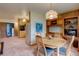 Cozy dining room features an adjacent kitchen and wood built-ins offering a warm and inviting space at 28858 Richmond Hill Rd, Conifer, CO 80433