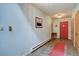 Inviting foyer featuring tiled flooring, a coat rack, and a bright red door at 28858 Richmond Hill Rd, Conifer, CO 80433
