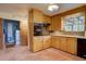 Functional kitchen with wood cabinets, modern appliances, and access to the laundry room provides great flow at 28858 Richmond Hill Rd, Conifer, CO 80433
