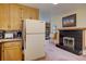 Charming kitchen featuring wood cabinets, vintage refrigerator, and breakfast nook with fireplace at 28858 Richmond Hill Rd, Conifer, CO 80433