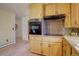 Cozy kitchen with stainless steel backsplash and appliances, and light wood cabinets at 28858 Richmond Hill Rd, Conifer, CO 80433