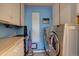 Well-equipped laundry room features modern appliances, ample counter space, and built in storage for added convenience at 28858 Richmond Hill Rd, Conifer, CO 80433