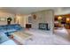 Spacious living room with fireplace featuring views into the dining room at 28858 Richmond Hill Rd, Conifer, CO 80433