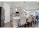Modern kitchen featuring gray cabinets, white countertops, stainless steel appliances, and island seating at 9750 Taylor River Cir, Littleton, CO 80125
