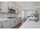 Open concept kitchen featuring gray cabinets, gas range, mosaic backsplash and white quartz countertop at 9750 Taylor River Cir, Littleton, CO 80125