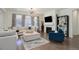 Comfortable living room with modern fireplace, built-in shelving and beautiful curtains at 9750 Taylor River Cir, Littleton, CO 80125