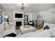 Inviting living room featuring a modern chandelier, fireplace, and comfortable white sofas at 9750 Taylor River Cir, Littleton, CO 80125