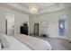 Well-lit main bedroom with views of the en suite bathroom and doorway to backyard at 9750 Taylor River Cir, Littleton, CO 80125