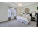 Bright main bedroom with large window, stylish lamps, and a decorative wall hanging at 9750 Taylor River Cir, Littleton, CO 80125