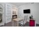 Bright home office featuring a modern desk, stylish chair, and French doors at 9750 Taylor River Cir, Littleton, CO 80125