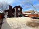 Exterior rear elevation featuring a barbecue, various tools, trash bags, and a concrete patio at 363 Wadsworth Cir, Longmont, CO 80504