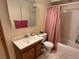 A bathroom including a toilet, bathtub, and single sink vanity cabinet at 363 Wadsworth Cir, Longmont, CO 80504