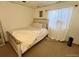 Cozy bedroom featuring natural lighting, a wooden bed, a wooden framed mirror, and neutral colored decor at 363 Wadsworth Cir, Longmont, CO 80504