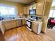 Well-lit kitchen with light wood cabinetry, stainless steel appliances, and tile flooring at 363 Wadsworth Cir, Longmont, CO 80504