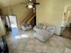 Inviting living room with tile floors, ceiling fan, and staircase to the upper level at 363 Wadsworth Cir, Longmont, CO 80504