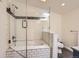 Modern bathroom featuring tiled shower-over-tub combo with glass door and mosaic accent tile at 347 Bannock St, Denver, CO 80223