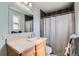 Well-lit bathroom featuring a vanity with a modern faucet and a shower with tile accents at 347 Bannock St, Denver, CO 80223