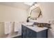 Updated bathroom featuring navy vanity with granite countertop, vessel sink, unique gold mirror, and tile backsplash at 347 Bannock St, Denver, CO 80223