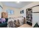 Cozy bedroom with plush bedding, natural light, and built-in shelving at 347 Bannock St, Denver, CO 80223