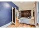 Charming bedroom featuring hardwood floors, blue accent wall, and built-in shelving, showcasing a cozy retreat at 347 Bannock St, Denver, CO 80223