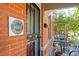 Historic Baker District signage on brick building next to black metal security door at 347 Bannock St, Denver, CO 80223