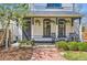 Charming front porch with rocking chairs and hanging plants on historic home at 347 Bannock St, Denver, CO 80223