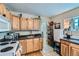 Functional kitchen featuring wood cabinets and dark countertops for convenient cooking at 347 Bannock St, Denver, CO 80223