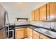 Well-lit kitchen with tile backsplash, stainless steel appliances, and ample counter space at 347 Bannock St, Denver, CO 80223