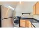 Kitchen features stainless steel appliances, countertops, and wood cabinets at 347 Bannock St, Denver, CO 80223