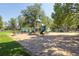 Community playground featuring slides, swings, and play structures surrounded by mature trees at 347 Bannock St, Denver, CO 80223