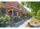 Charming row of brick townhomes with landscaped front yards and inviting porches at 347 Bannock St, Denver, CO 80223