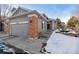 This home features a gray exterior, brick accents, and a welcoming front entrance at 3537 W 125Th Cir, Broomfield, CO 80020