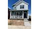 Charming two-story home with a modern color scheme and inviting front porch at 725 Cottonwood Ave, Bennett, CO 80102