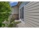 Back patio, showcasing the private outdoor entrance with exterior siding and some foliage around providing shade at 18384 E Bethany Pl, Aurora, CO 80013
