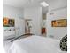 Airy bedroom showcases skylights, neutral decor, and convenient access to the bathroom and kitchen at 18384 E Bethany Pl, Aurora, CO 80013