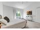Bright bedroom featuring a comfortable bed, white walls, balcony access, and stylish decor, creating a cozy retreat at 18384 E Bethany Pl, Aurora, CO 80013