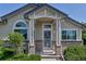 Charming home features a covered front porch with brick accents and well-maintained landscaping at 18384 E Bethany Pl, Aurora, CO 80013