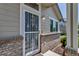 Close-up of the front entrance showing the security door, brick detail and well-kept exterior at 18384 E Bethany Pl, Aurora, CO 80013