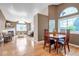 Open concept living and dining area with hardwood floors and large windows at 18384 E Bethany Pl, Aurora, CO 80013