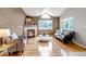 Bright living room boasts hardwood floors, a fireplace, and plenty of natural light at 18384 E Bethany Pl, Aurora, CO 80013