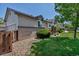Side yard view shows manicured landscaping, a privacy fence, and the home's exterior at 18384 E Bethany Pl, Aurora, CO 80013