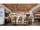 Basement wet bar with wood ceiling, modern lighting, and lots of seating at 5261 Sedona Dr, Parker, CO 80134
