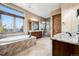 Luxurious bathroom with soaking tub, walk-in shower, and dual vanities at 5261 Sedona Dr, Parker, CO 80134