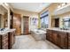 Elegant bathroom featuring a soaking tub, dual vanities, and beautiful tile work at 5261 Sedona Dr, Parker, CO 80134