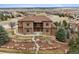Elegant two-story home boasts stone accents, lush landscaping, and large bay windows at 5261 Sedona Dr, Parker, CO 80134