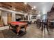 Entertain in style in this rustic basement game room with pool table and bar area at 5261 Sedona Dr, Parker, CO 80134