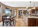 Open-concept kitchen and dining area with wood floors and island with granite counters at 5261 Sedona Dr, Parker, CO 80134