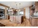 Gourmet kitchen with stainless steel appliances, a large center island, custom cabinets, and hardwood floors at 5261 Sedona Dr, Parker, CO 80134